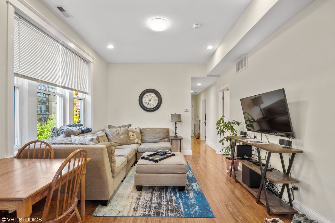 The Evergreen — living room in the same unit, hardwood floors