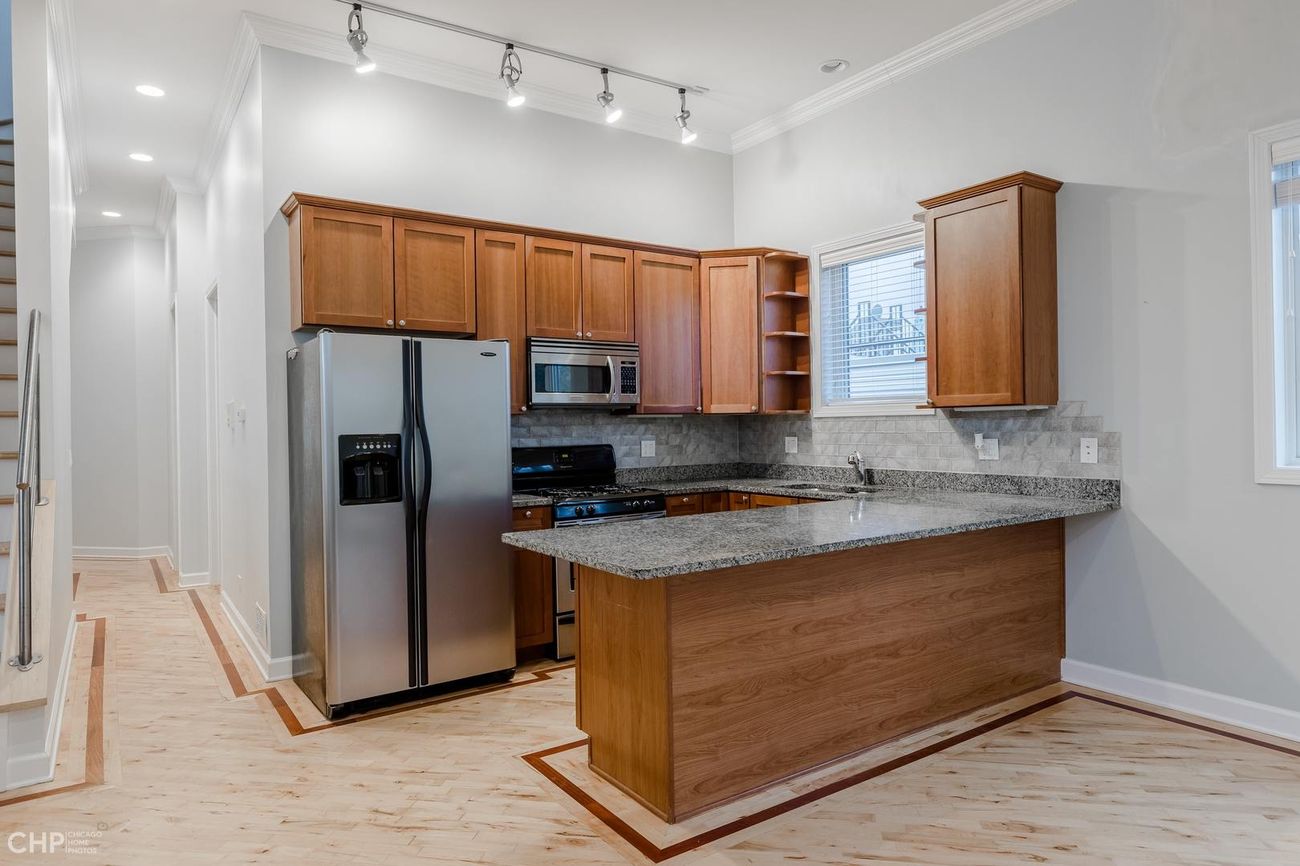 Logan Square 2BD — kitchen with staircase to private deck