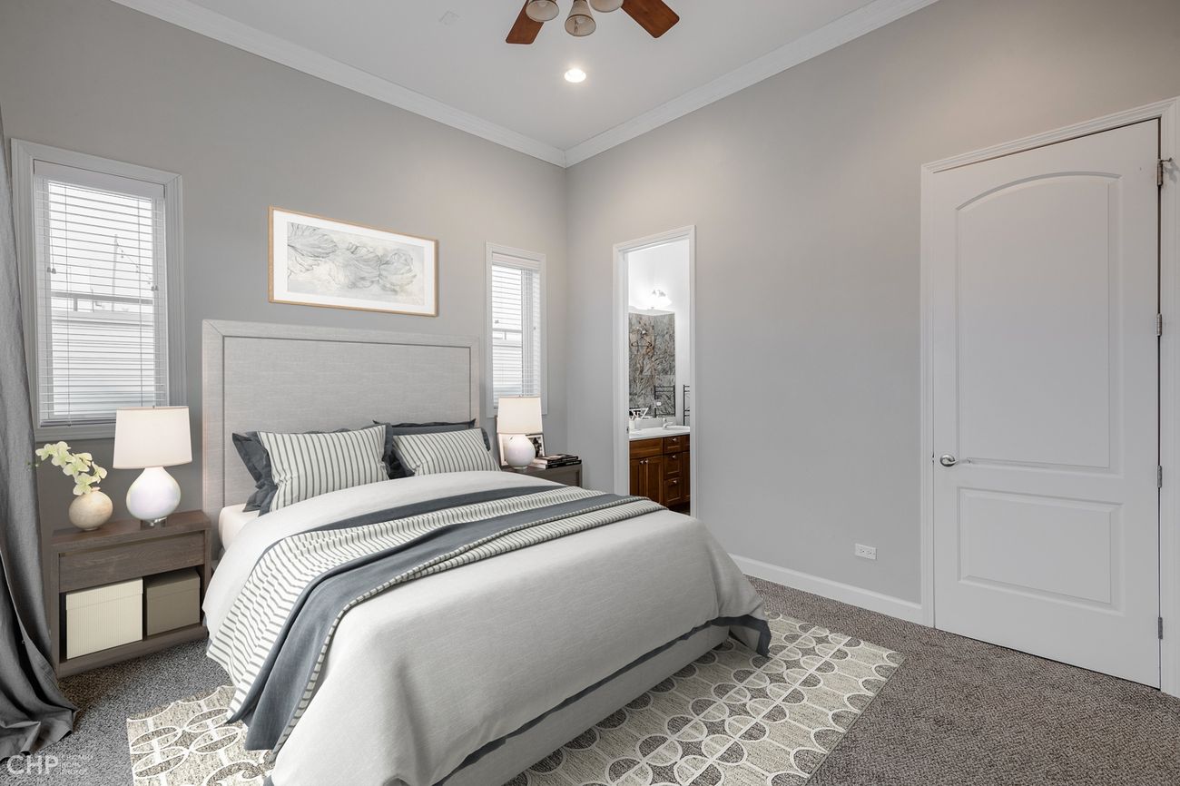 Logan Square 2BD — primary bedroom with en-suite bath doorway
