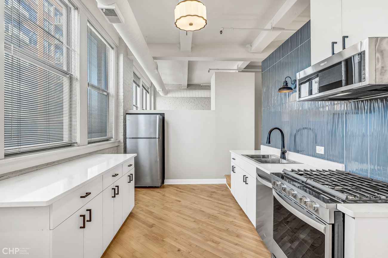 Sangamon Loft 1 — galley kitchen with stainless appliances and quartz counters