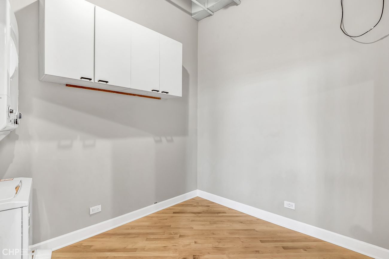 Sangamon Loft 1 — in-unit laundry closet with upper cabinetry
