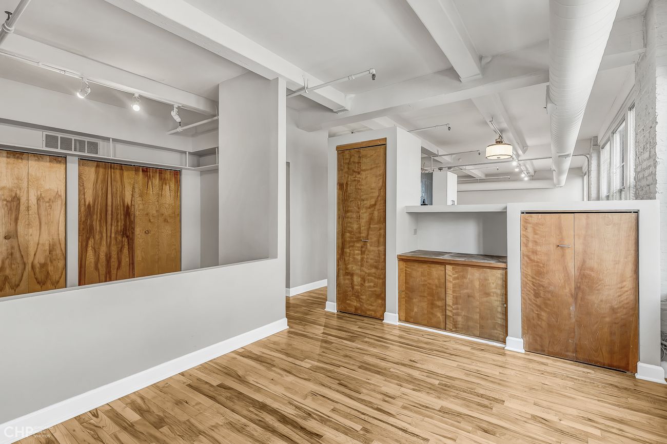 Sangamon Loft 1 — built-in wood storage cabinetry off the entry
