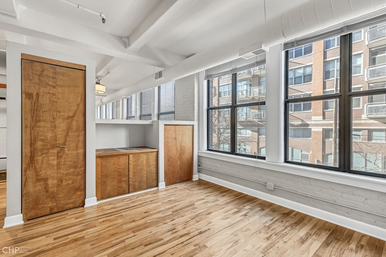 Sangamon Loft 1 — built-in wood storage cabinetry near the windows
