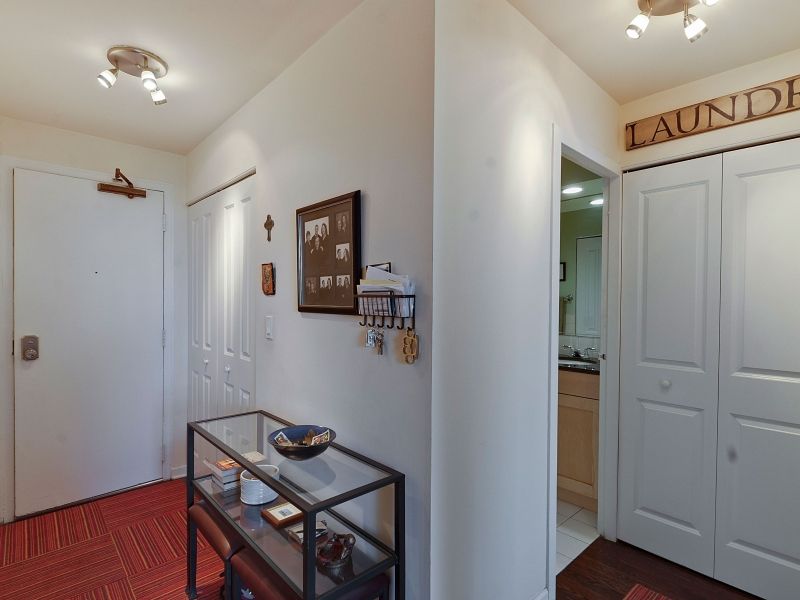 Sheridan Tower Condo — entry hallway with laundry closet