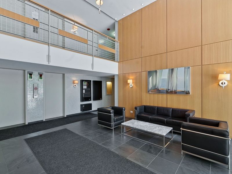 Sheridan Tower Condo — double-height building lobby with seating area