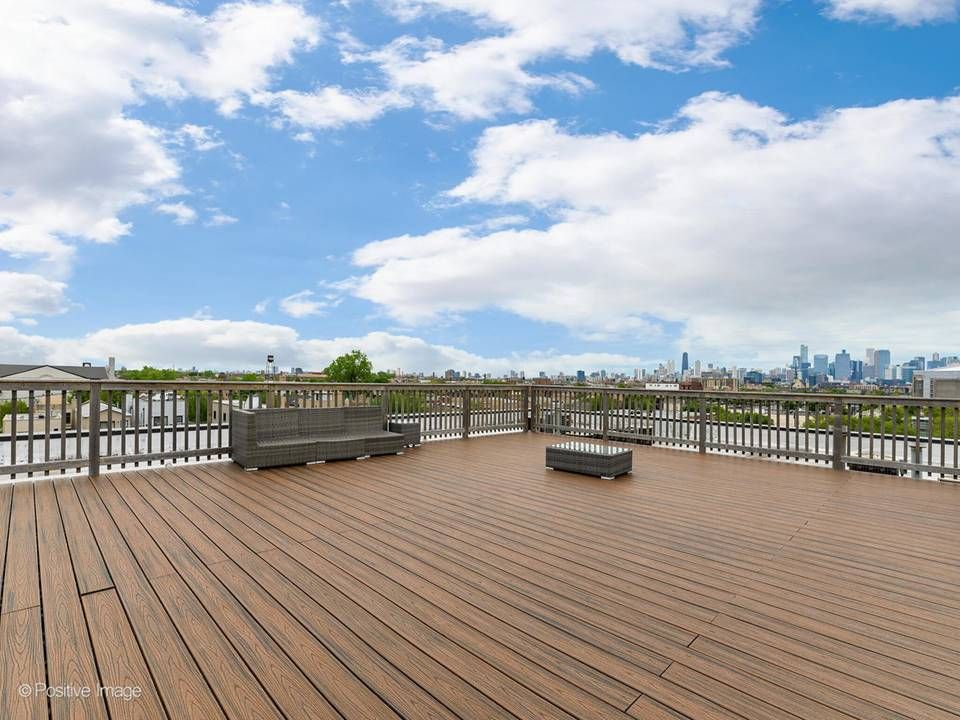 The South Leavitt — building rooftop deck with downtown skyline view