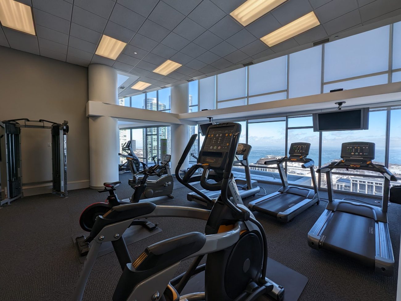 Building amenity — fitness center with skyline views