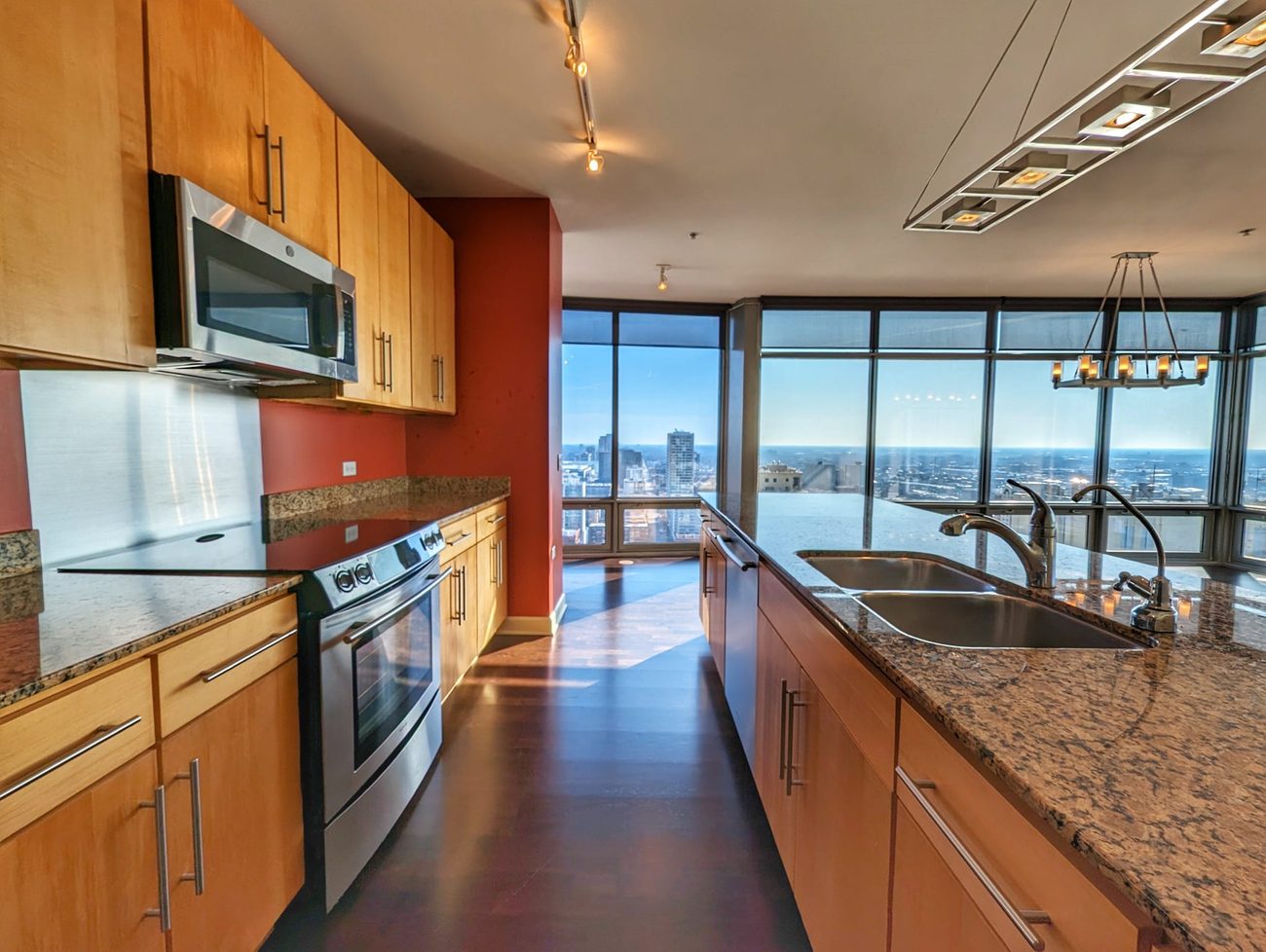 South Loop Penthouse — kitchen with granite counters and skyline view