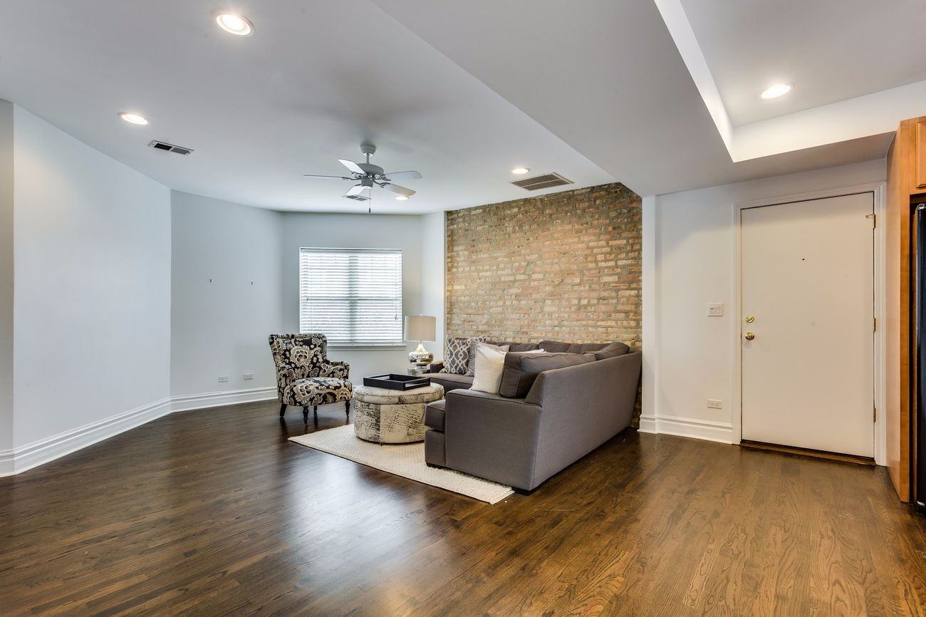 Troy St — living room with exposed brick accent wall