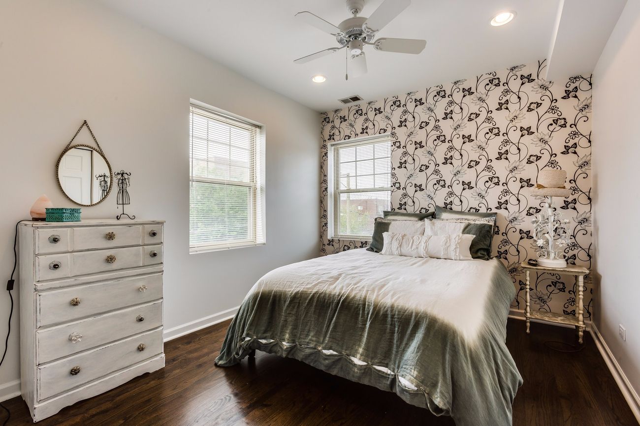 Troy St — primary bedroom with floral accent wallpaper