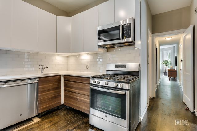 Ukrainian Village 6 — unit kitchen with stainless appliances and subway tile