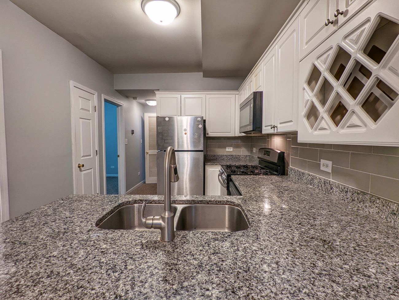 Walton Street Fourplex — unit kitchen with granite counters