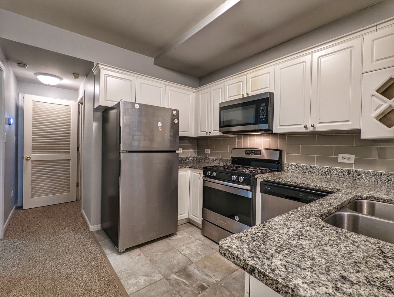 Walton Street Fourplex — unit kitchen with stainless appliances