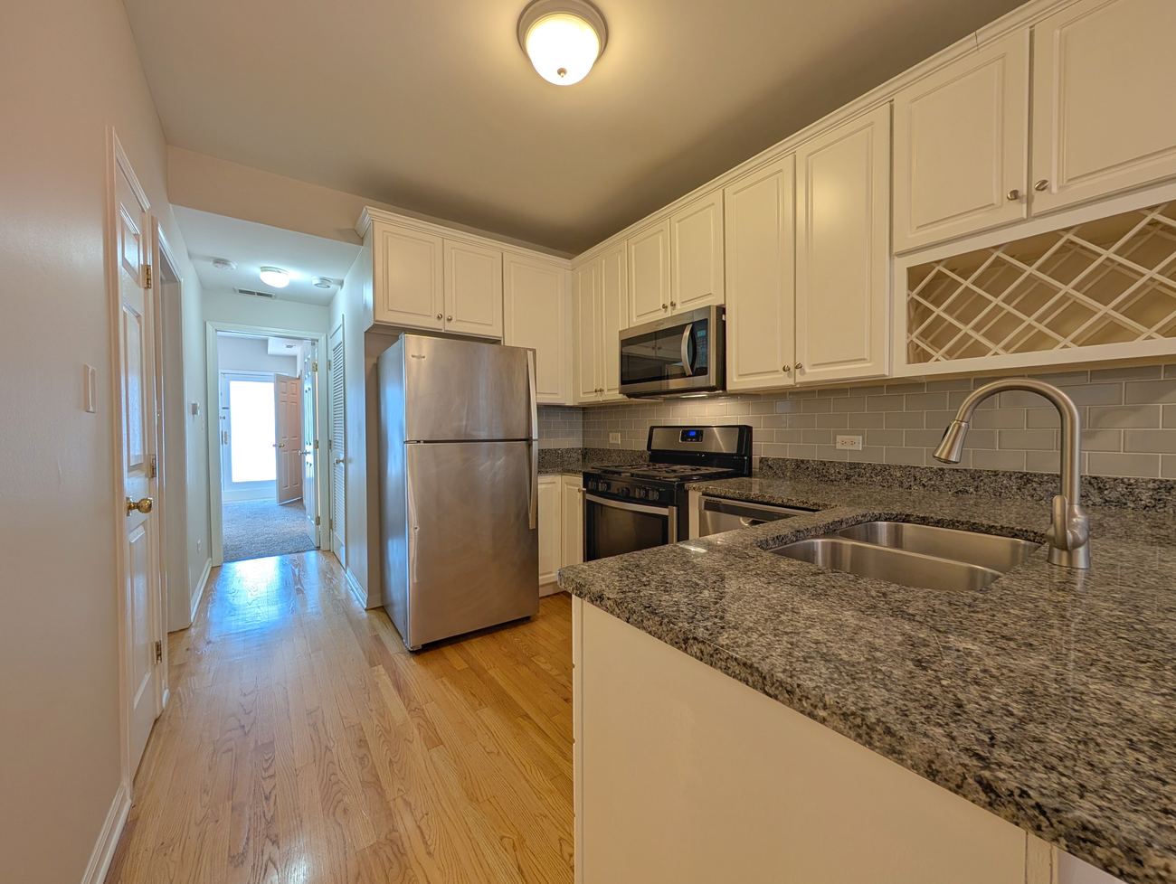 Walton Street Fourplex — unit kitchen with subway tile backsplash