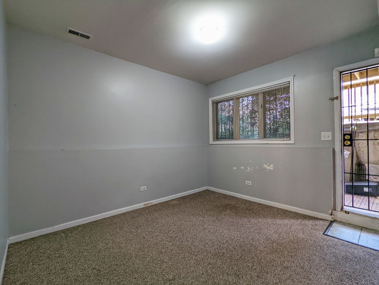 Walton Street Fourplex — lower-level room with walkout access