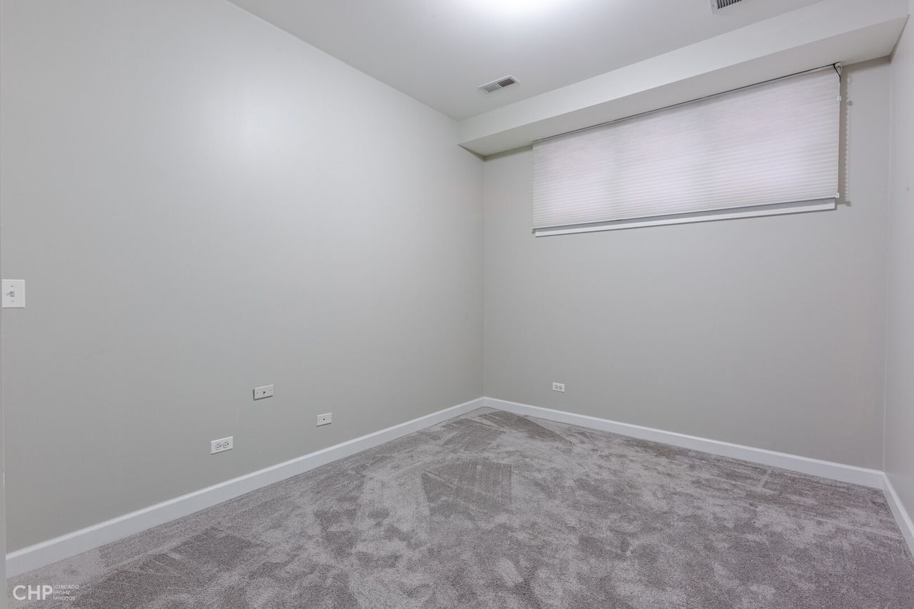 West Lakeview Duplex — lower-level bedroom