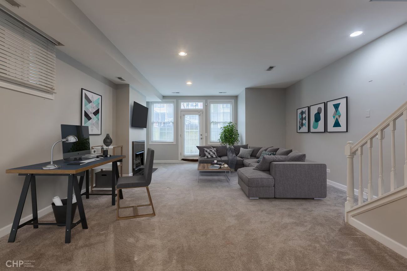 West Lakeview Duplex — lower-level family room with walkout to the deck